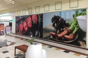 Wall graphics line the pedestrian walkways through the shopping centres in Perth and can feature products and services available from the stores within.