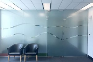 Window frosting makes a stylish privacy screen in between internal office spaces, like this example with a simple wave of clear space, printed and installed by Imagesource Perth