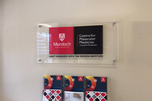 Imagesource produce premium acrylic signage for medical reception areas - this sign for Murdoch University has brushed metal stand offs used for wall mounting