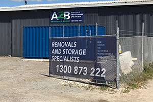 An ACM sign and banner mesh with the brand colours for the A2B Removals workshop