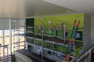 The Imagesource signage install team at Methodist Ladies College installing a huge wall graphic